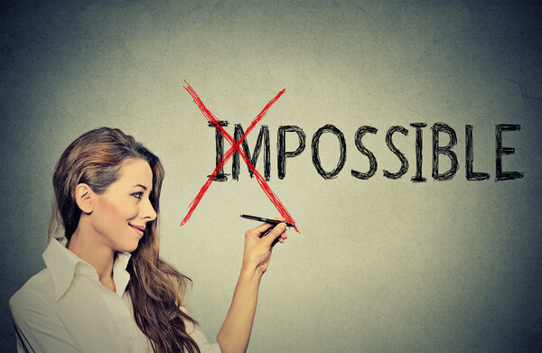 happy woman converting the word impossible to possible