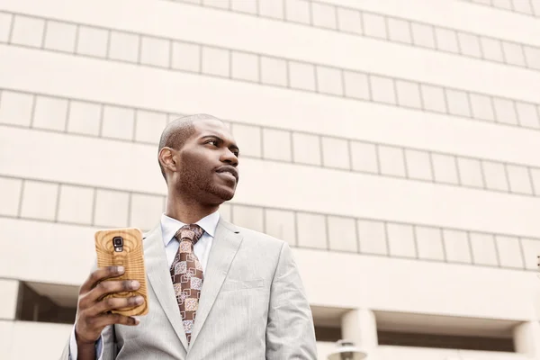 Closeup handsome young businessman with mobile phone outdoors — Stock Photo, Image