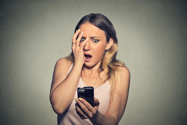 Anxious scared young girl looking at phone seeing bad news — Stock Fotó