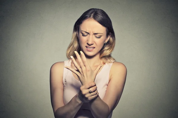 Young woman holding her painful wrist. Sprain pai — Zdjęcie stockowe