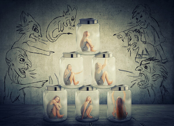 lonely woman sitting in a pile of glass jars surrounded by angry