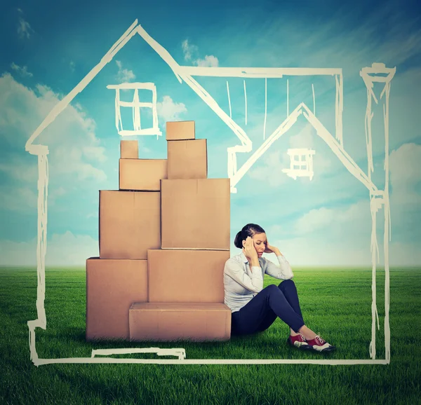 Young stressed woman sitting on the ground green grass with many — Stock Photo, Image