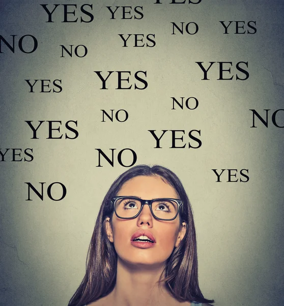 Thinking young woman with yes or no choice looking up — Stock Photo, Image