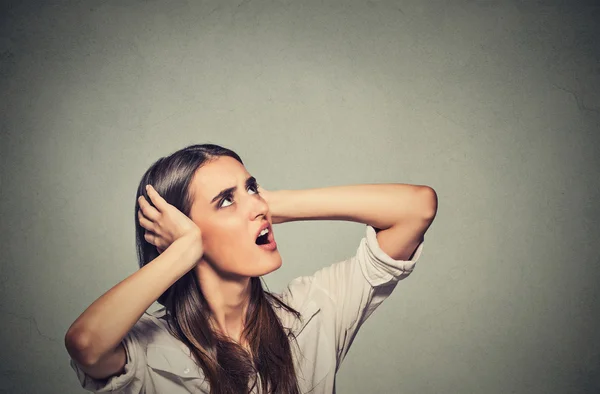 Annoyed stressed woman covering her ears, looking up loud noise upstairs — Stock Photo, Image