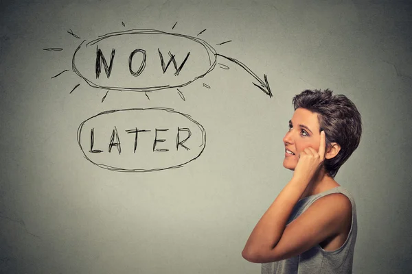 Now or later. Woman thinking looking up — Stock Photo, Image