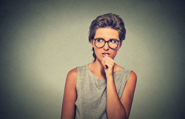 nervous looking woman biting her fingernails craving something anxious