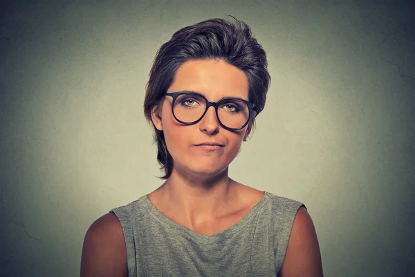 Skeptic. Doubtful woman in glasses looking at you — Zdjęcie stockowe