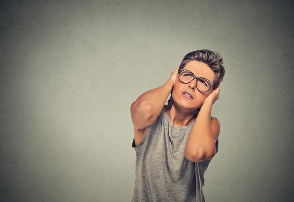 Annoyed, unhappy, stressed woman covering her ears, looking up — 图库照片