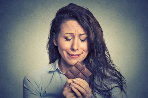 woman tired of diet restrictions craving sweets chocolate