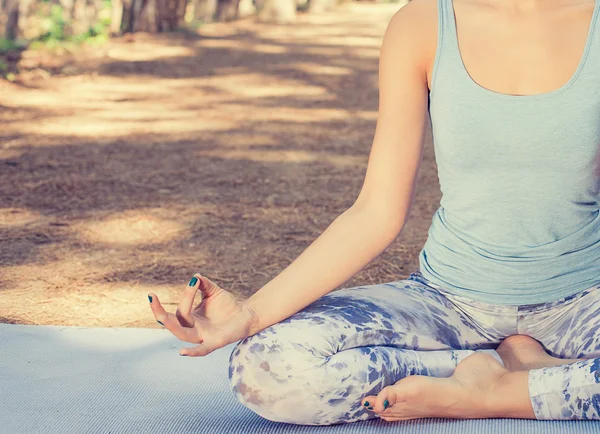 Beautiful young woman meditating outdoors in spring summer park — Stock Photo, Image