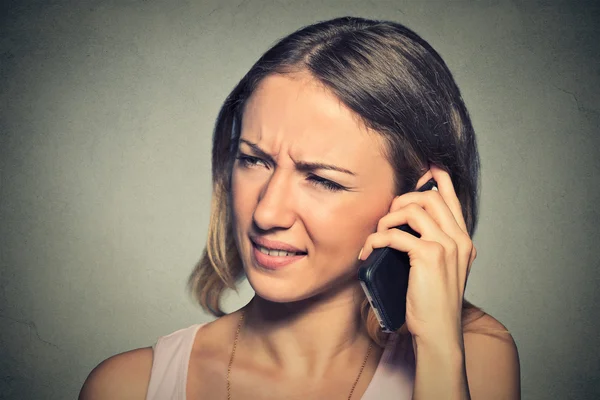 Upset sad annoyed unhappy woman talking on cell phone Stock Photo