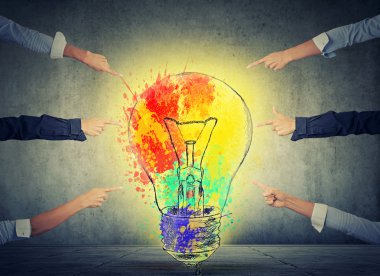 Human arms fingers point at bright idea colorful glowing light bulb
