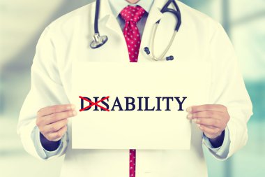 doctor hands holding sign disability crossing through the Dis with red marker