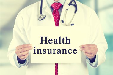doctor hands holding white card sign with health insurance text message