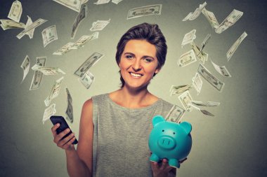 woman using smartphone with dollar bills banknotes flying away from screen