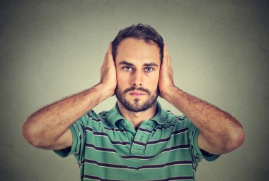 young man covering his ears with hands clipart