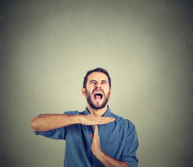 Young man showing time out hand gesture, frustrated screaming to stop clipart