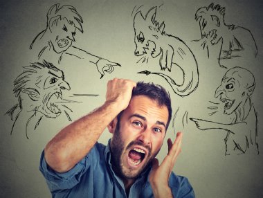 Evil men pointing at stressed anxious guy