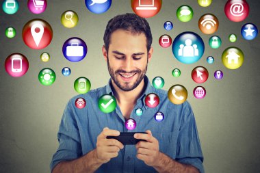 Happy man using texting on smartphone social media application icons flying out