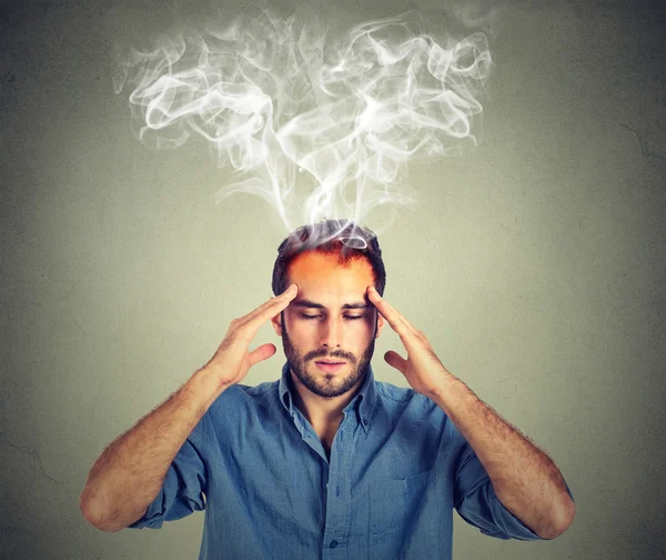 Man thinks very intensely having headache isolated on gray wall background — Stock Photo, Image