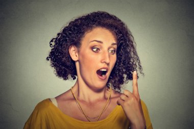 Shocked surprised woman looking at her forefinger