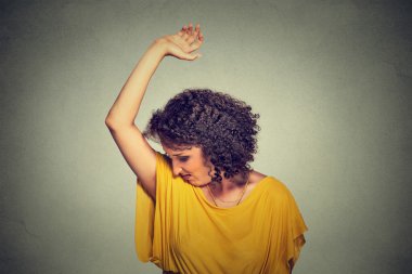 woman, smelling, sniffing her wet armpit, something stinks, very bad foul odor