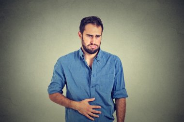 Young man with stomach pain indigestion clipart