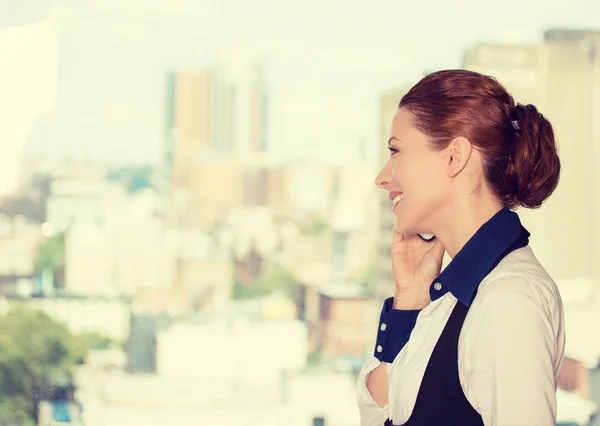 Business woman talking on mobile phone standing by office window with city urban background — 图库照片