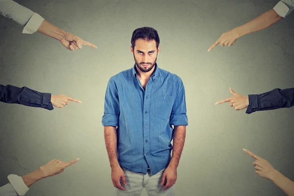 Sad depressed upset man looking down many fingers pointing at him — Stockfoto