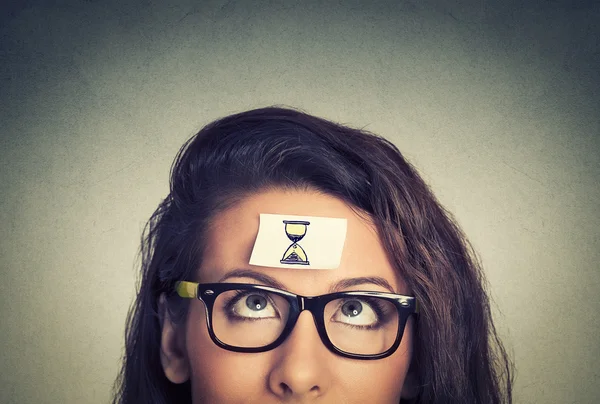 Time management concept young woman with sand clock sign — Stockfoto