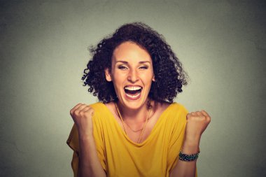 happy woman exults pumping fists ecstatic celebrates success on gray background clipart