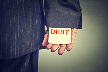 Debt concept. Closeup business man hiding debt card in a suit sleeve  