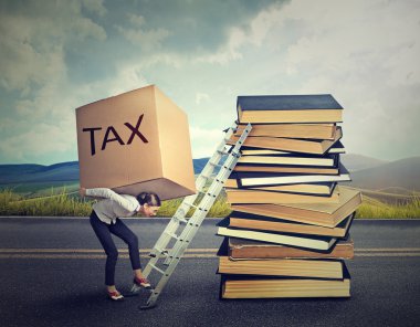 Tax debt concept. Woman with heavy box full of tax debt carrying it up career ladder 