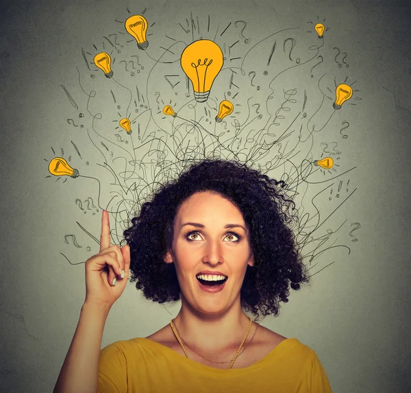 Excited woman with many ideas light bulbs above head looking up — Stock Photo, Image