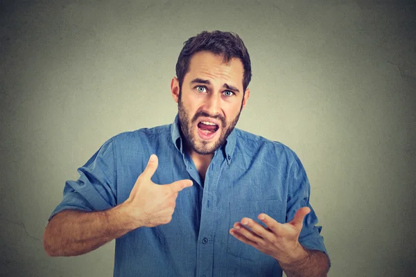 Angry guy pointing at himself asking you mean me, you talking to me — Stock Photo, Image
