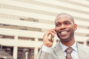 headshot handsome happy laughing young business man talking on mobile phone 