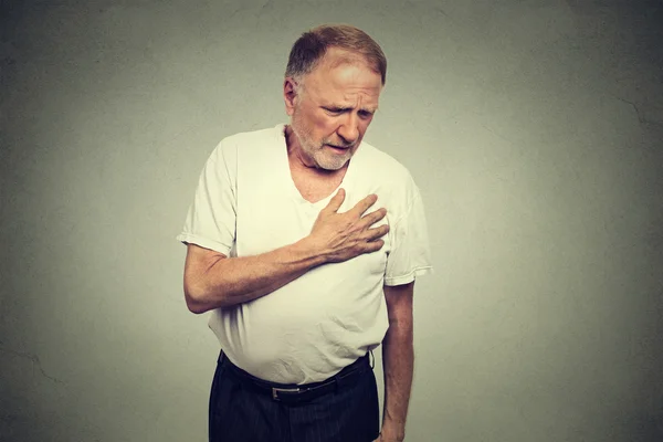 Senior mature man suffering from bad pain in his chest heart attack — Stok fotoğraf