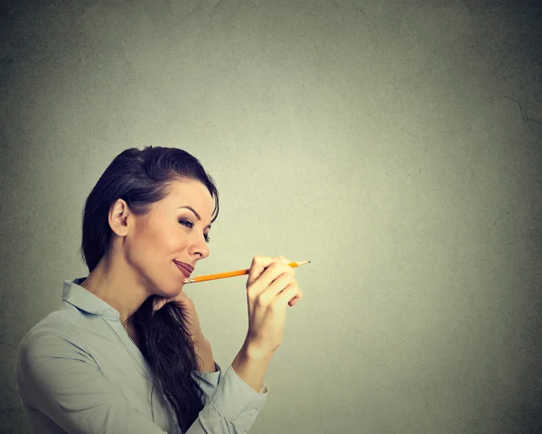 Woman writing with pencil on a wall isolated on gray background — 图库照片