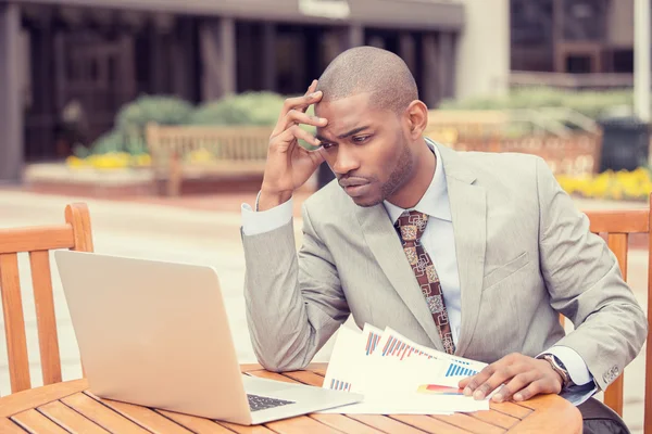 Busy man investment consultant analyzing company financial report balance sheet statement