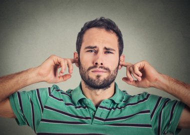 headshot displeased man plugging ears with fingers doesn't want to listen 