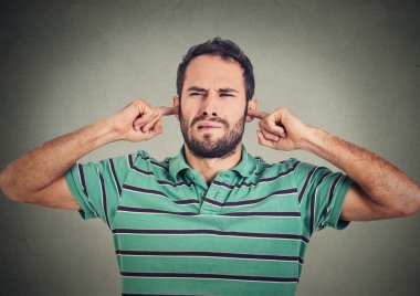 headshot displeased man plugging ears with fingers doesn't want to listen 