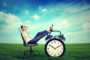 young business woman corporate executive relaxing sitting on a chair in the open air outdoors 