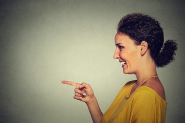 side view profile portrait of attractive woman pointing and laughing at someone