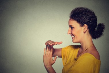 Side profile portrait, young, happy, smiling woman showing time out gesture