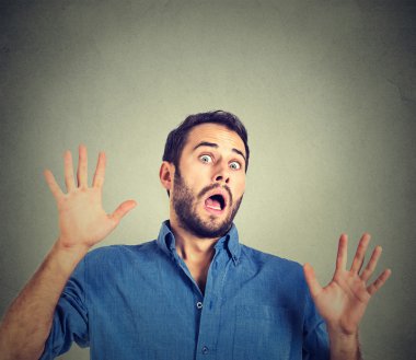 scared man on gray wall background