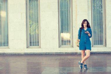 Smiling beautiful woman texting with her smart phone