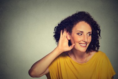 happy middle aged nosy woman hand to ear gesture carefully secretly listening 