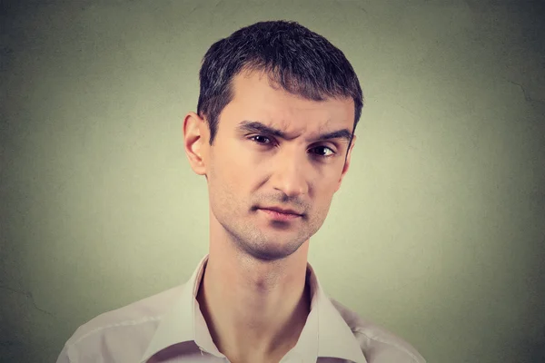 Skeptical man looking suspicious, some disgust on his face — Stock Photo, Image