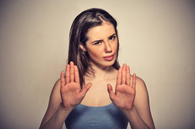 annoyed angry woman with bad attitude gesturing with palms outward to stop