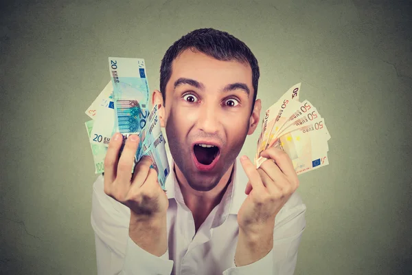 Happy young man with money euro banknotes ecstatic celebrates success — Stock Photo, Image